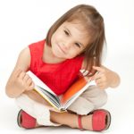 Child with a book | Kootenai County Farmers' Market